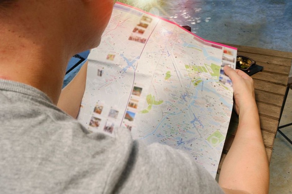 A folded city map held open during a quiet trip planning moment.