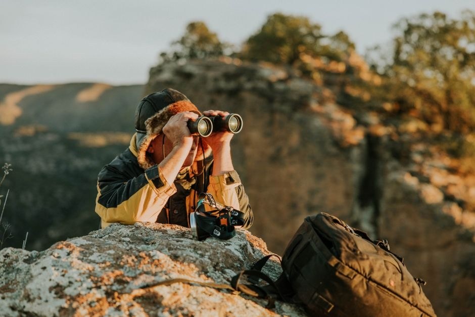 A photographer using a camera outdoors